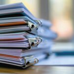 organized stack documents tidy office desk with soft sunlight
