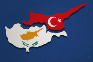 Map of Cyprus divided into North and South, with the northern part in red featuring the Turkish flag and the southern part in white with the Cyprus flag on a blue background.