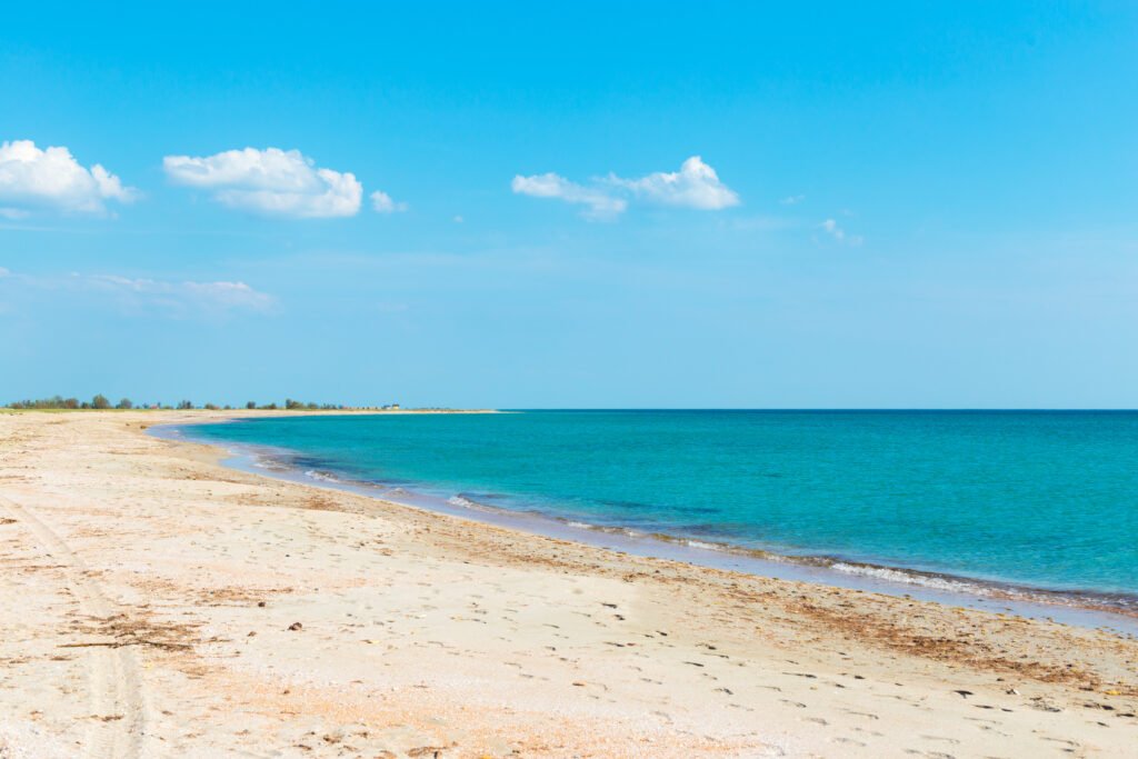 Turquoise beach with clear blue sky — perfect coastal escape.