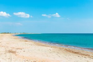 Turquoise beach with clear blue sky — perfect coastal escape.