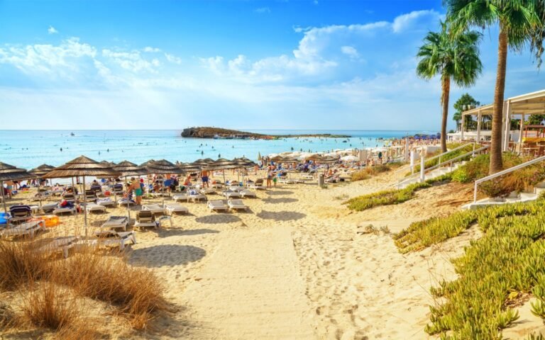 Long sandy beach in Famagusta with turquoise water and clear Mediterranean coastline.