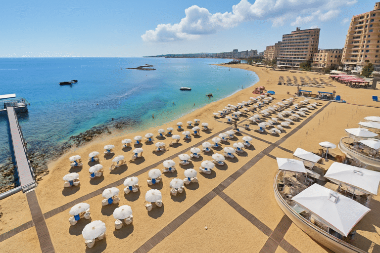 Palm Beach in Famagusta with golden sand, turquoise water, and a calm Mediterranean shoreline.